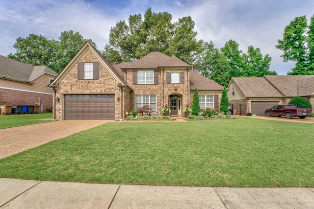 view of front of house featuring a garage and a front lawn