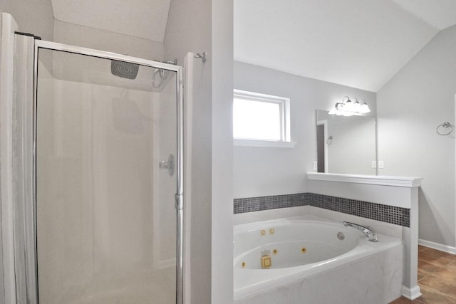 bathroom featuring vaulted ceiling and shower with separate bathtub