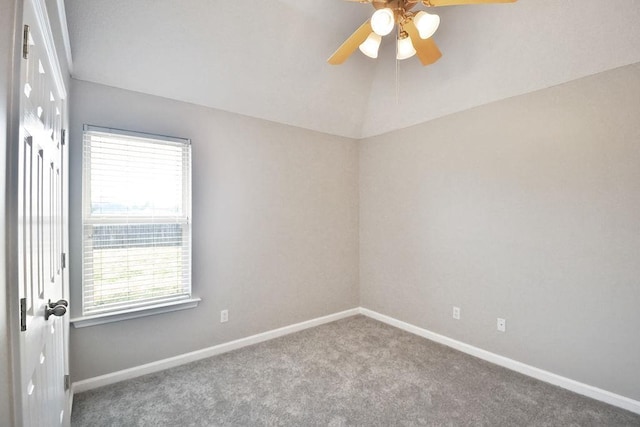 carpeted empty room featuring vaulted ceiling and ceiling fan