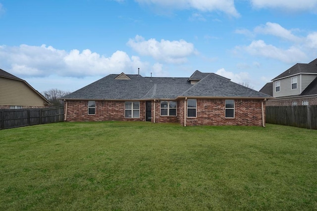 rear view of property featuring a yard