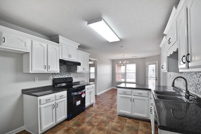 kitchen featuring sink, black electric range, kitchen peninsula, pendant lighting, and white cabinets