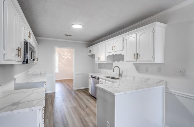 kitchen featuring sink, stainless steel appliances, ornamental molding, light stone countertops, and white cabinets