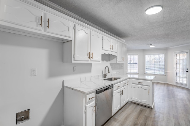 kitchen featuring sink, dishwasher, white cabinetry, a wealth of natural light, and kitchen peninsula