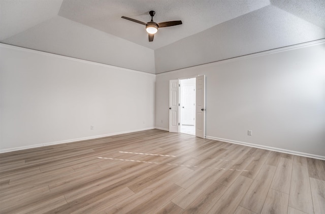 spare room featuring vaulted ceiling, a textured ceiling, ceiling fan, and light hardwood / wood-style flooring