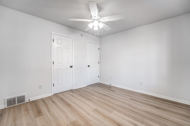 unfurnished bedroom with ceiling fan and light hardwood / wood-style floors