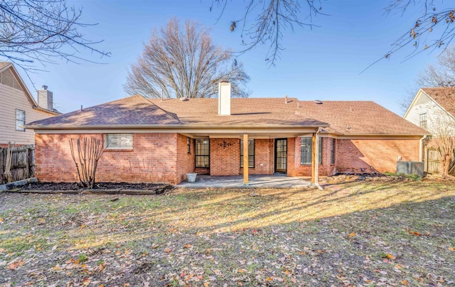 back of property with a yard, central AC unit, and a patio