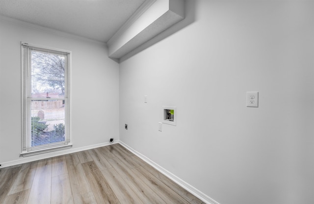 laundry area featuring washer hookup, crown molding, hookup for an electric dryer, and light wood-type flooring