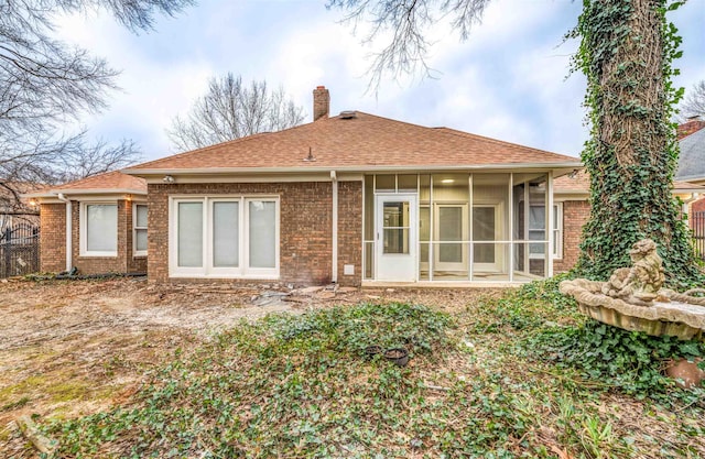 rear view of property with a sunroom