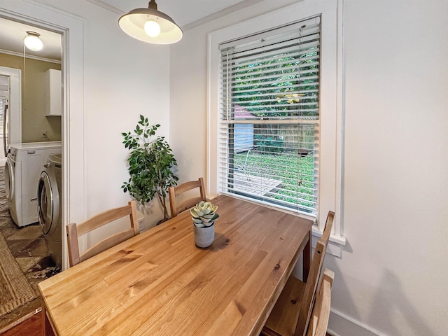 dining room featuring ornamental molding and washing machine and clothes dryer