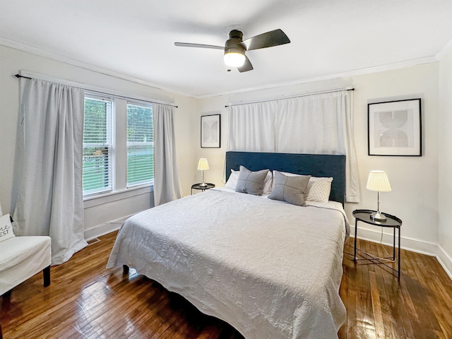 bedroom with ceiling fan, ornamental molding, and dark hardwood / wood-style floors