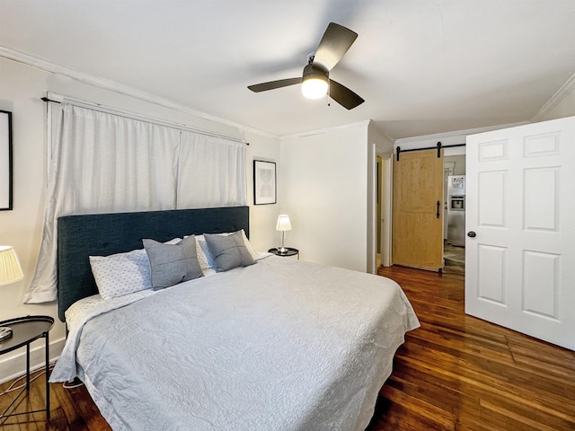 bedroom with ceiling fan, ornamental molding, dark hardwood / wood-style flooring, stainless steel fridge with ice dispenser, and a barn door