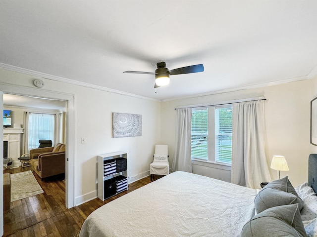 bedroom with dark hardwood / wood-style flooring, crown molding, and ceiling fan