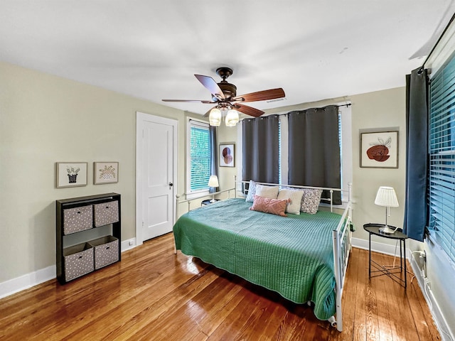 bedroom with hardwood / wood-style flooring and ceiling fan