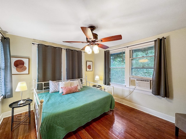 bedroom featuring cooling unit, ceiling fan, and dark hardwood / wood-style flooring