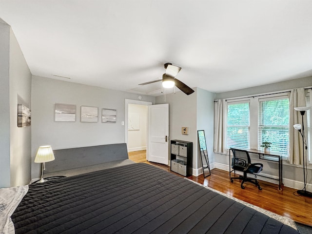 bedroom with hardwood / wood-style flooring and ceiling fan