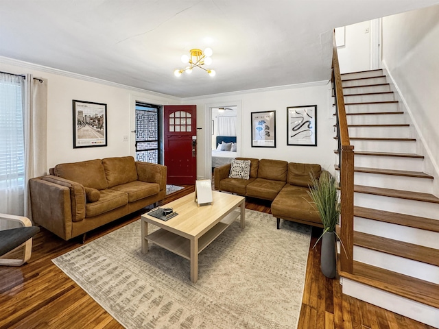 living room with ornamental molding, dark wood-type flooring, and a notable chandelier