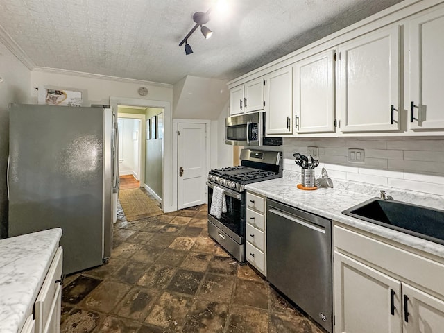 kitchen with white cabinetry, sink, tasteful backsplash, and stainless steel appliances