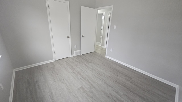 unfurnished bedroom with light wood-type flooring