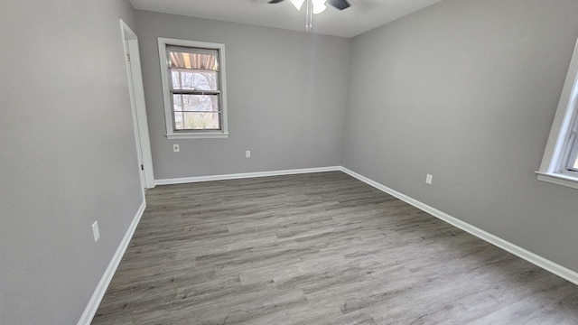 unfurnished room with hardwood / wood-style flooring and ceiling fan