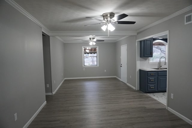 unfurnished dining area with sink, ornamental molding, and a healthy amount of sunlight