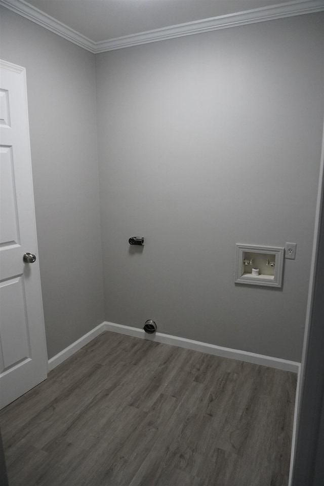 laundry room with crown molding, hookup for a washing machine, dark wood-type flooring, and electric dryer hookup