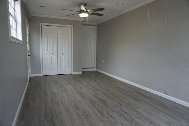 unfurnished bedroom featuring ornamental molding, hardwood / wood-style floors, ceiling fan, and a closet