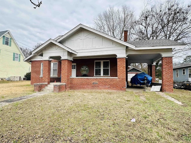 bungalow-style home with a carport and a front yard