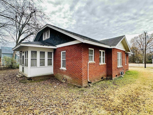 view of property exterior with a sunroom