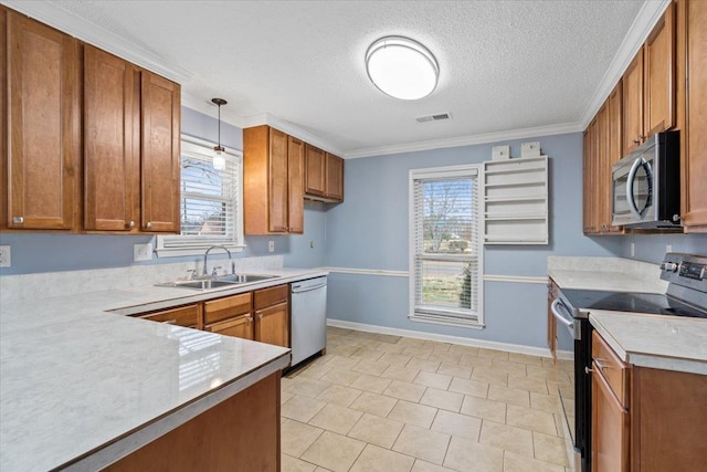 kitchen featuring sink, decorative light fixtures, plenty of natural light, and stainless steel appliances