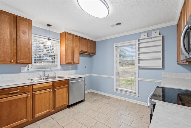 kitchen featuring hanging light fixtures, stainless steel appliances, sink, and a healthy amount of sunlight