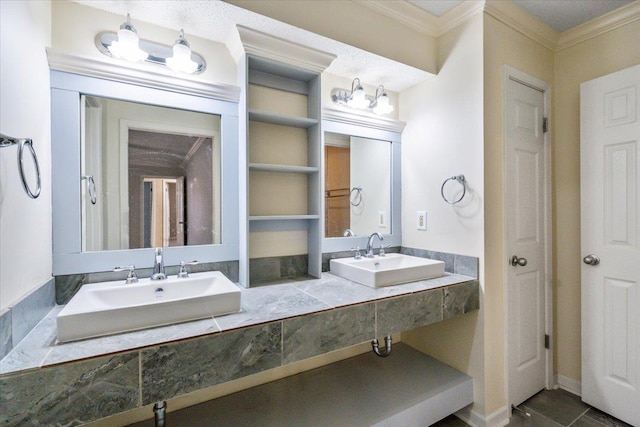 bathroom with crown molding, double vanity, and a sink