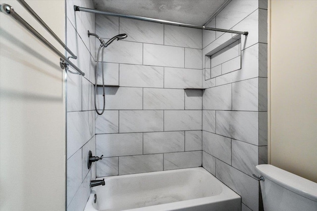 bathroom with tiled shower / bath and toilet