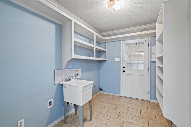 washroom with hookup for an electric dryer, hookup for a washing machine, and a textured ceiling