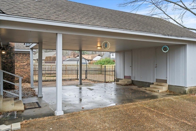 view of patio / terrace with a carport, entry steps, and fence