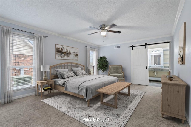 bedroom with a textured ceiling, light colored carpet, visible vents, and ornamental molding