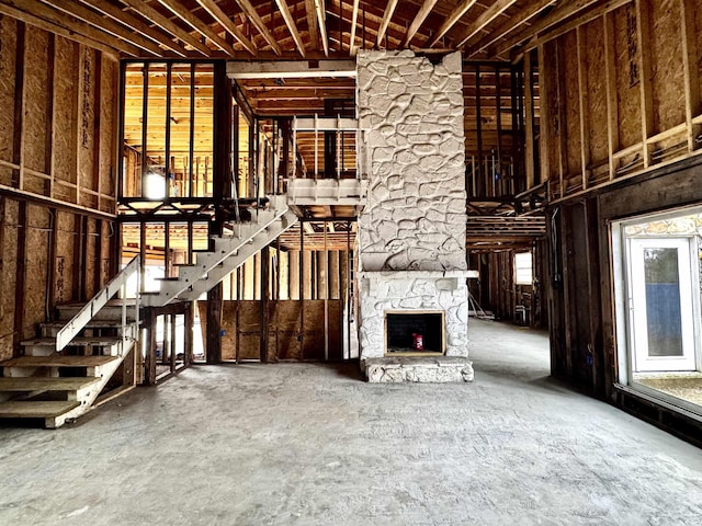 unfurnished living room featuring a stone fireplace