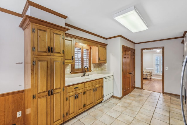 kitchen featuring sink, dishwasher, tasteful backsplash, ornamental molding, and light tile patterned flooring