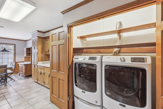 laundry area with light tile patterned floors, ornamental molding, and independent washer and dryer