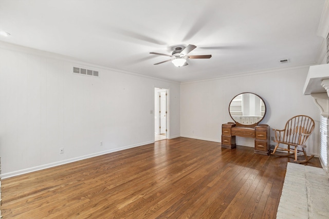 empty room with crown molding, dark wood-type flooring, and ceiling fan