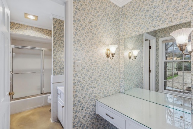 full bathroom with toilet, ornamental molding, vanity, and shower / bath combination with glass door