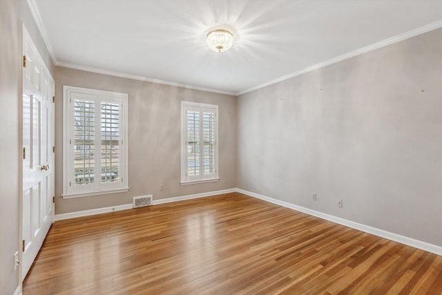 unfurnished room with crown molding, light hardwood / wood-style flooring, and a wealth of natural light