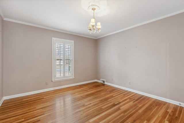 unfurnished room with an inviting chandelier, ornamental molding, and wood-type flooring