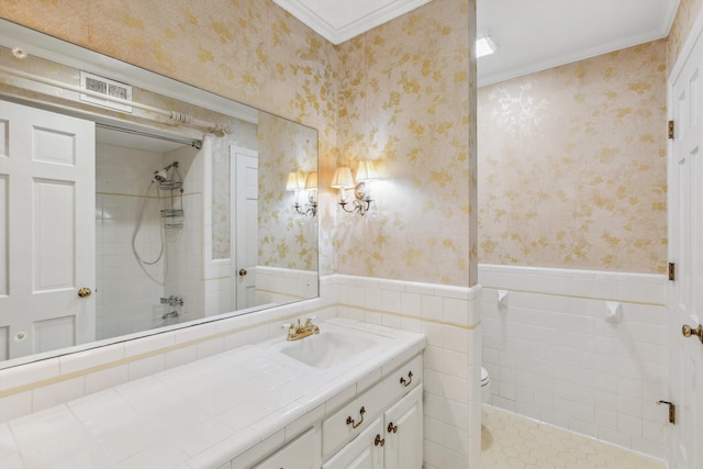 bathroom with tiled shower, vanity, tile walls, and ornamental molding