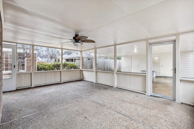 unfurnished sunroom with ceiling fan