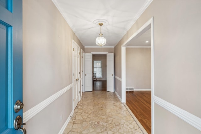 interior space featuring crown molding and a chandelier