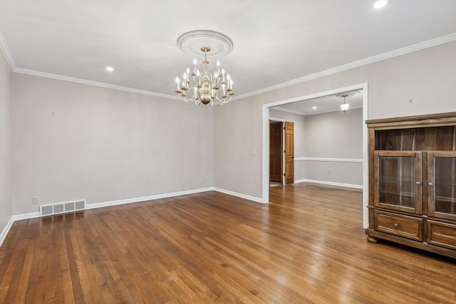 unfurnished room with crown molding, wood-type flooring, and a notable chandelier