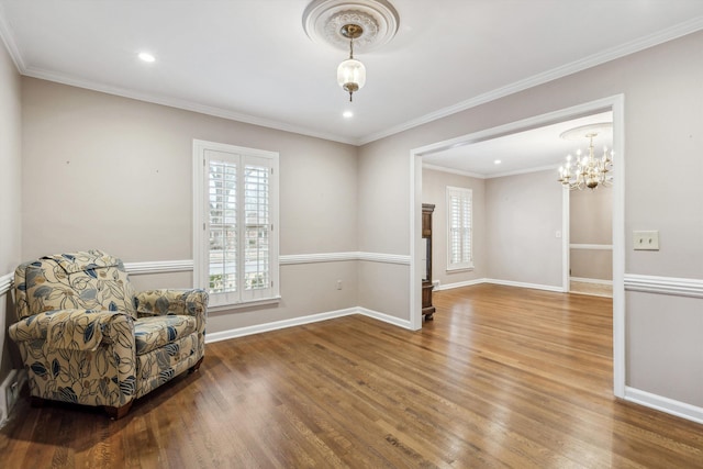 living area featuring crown molding and hardwood / wood-style floors