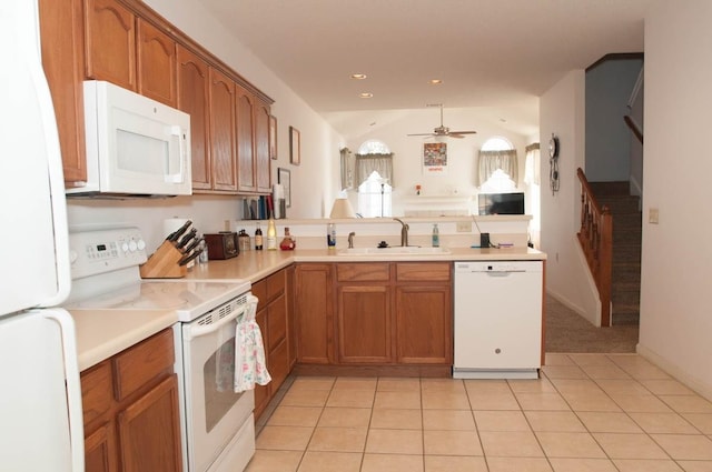 kitchen with sink, vaulted ceiling, light tile patterned floors, ceiling fan, and white appliances