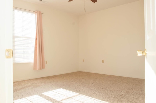 carpeted empty room featuring ceiling fan