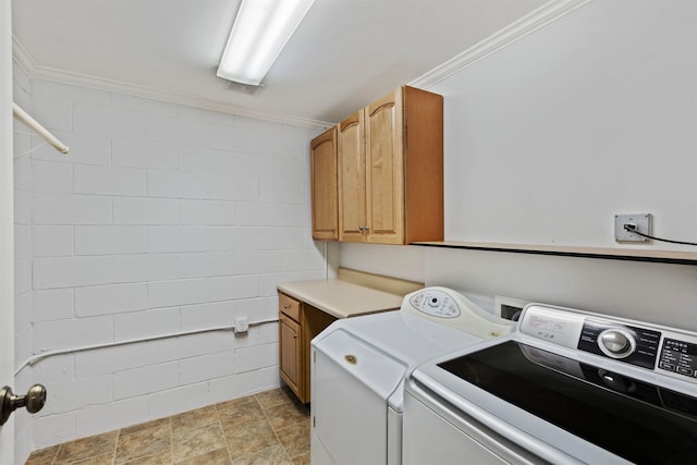 laundry area featuring cabinets, washing machine and clothes dryer, and ornamental molding